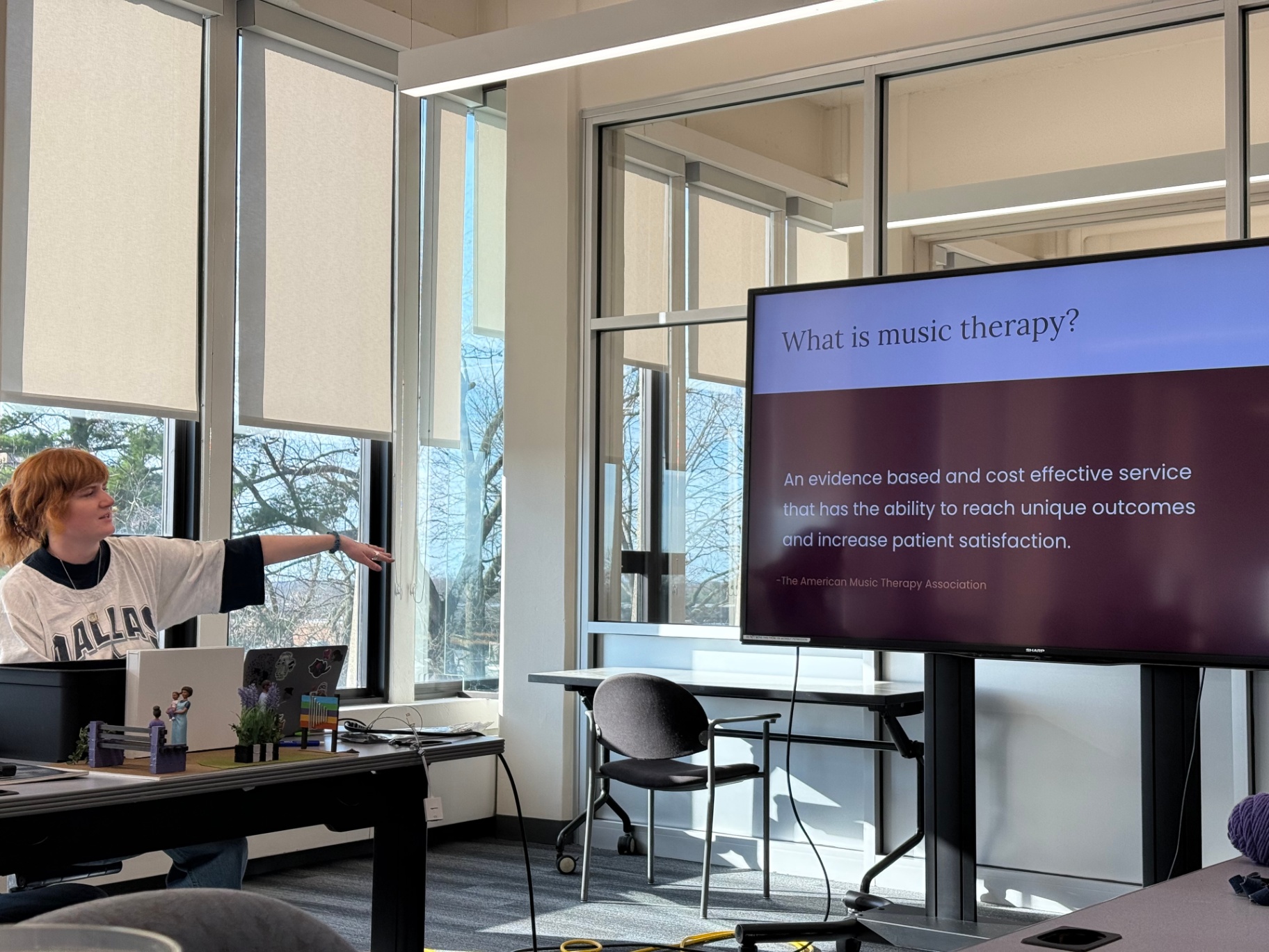 Slide explaining what music therapy is, cited from the American Music Therapy Association